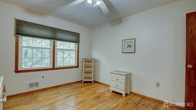unfurnished bedroom featuring light wood-type flooring, baseboards, and ceiling fan