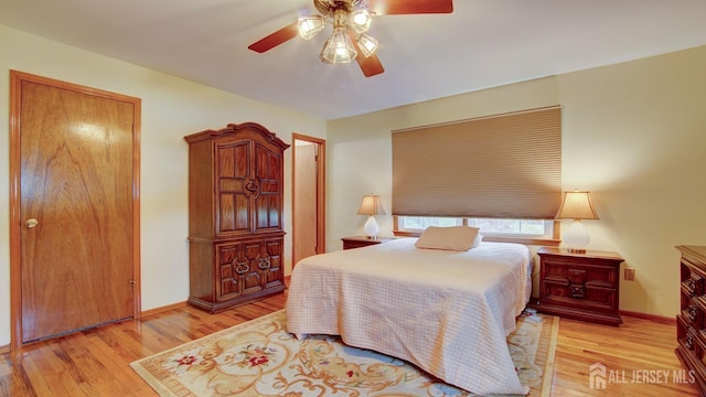 bedroom with wood finished floors, ceiling fan, and baseboards