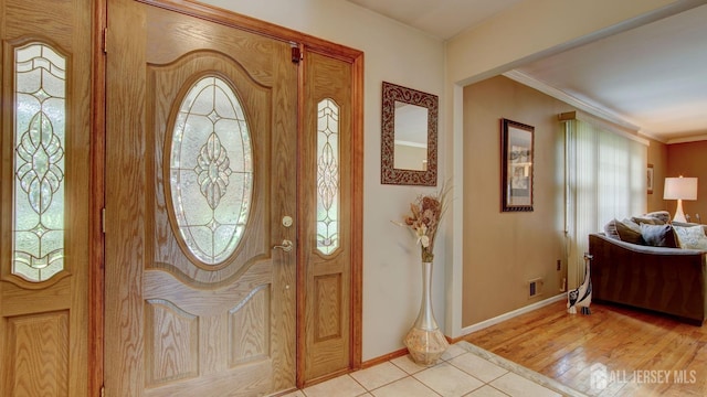 entryway featuring baseboards and light tile patterned flooring