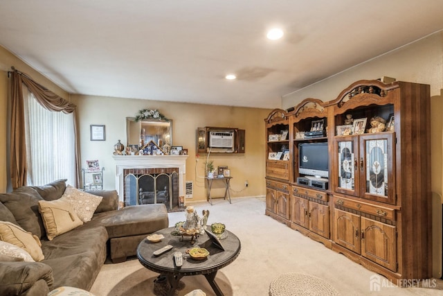 living room with a brick fireplace, recessed lighting, a wall mounted AC, and light carpet