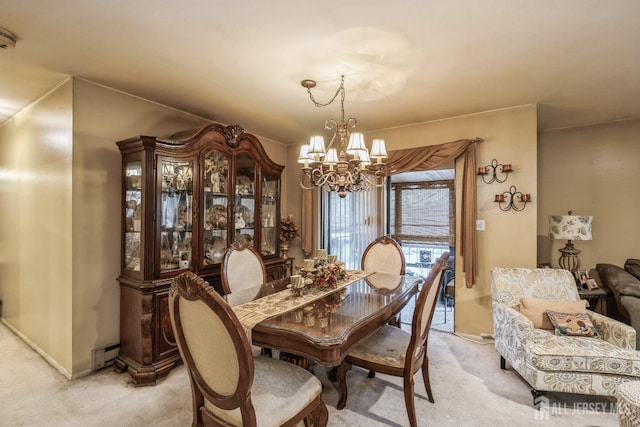 dining space featuring an inviting chandelier, baseboard heating, light carpet, and baseboards