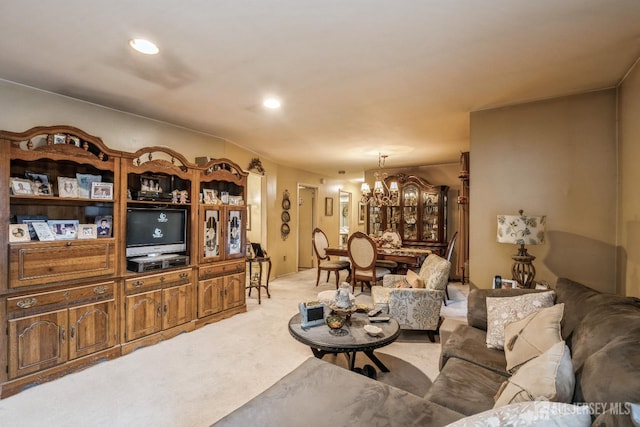 living room featuring recessed lighting, light carpet, and an inviting chandelier