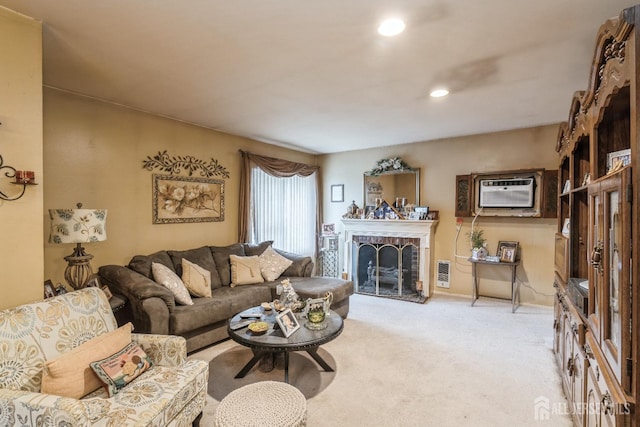 living area with recessed lighting, light carpet, a brick fireplace, an AC wall unit, and visible vents