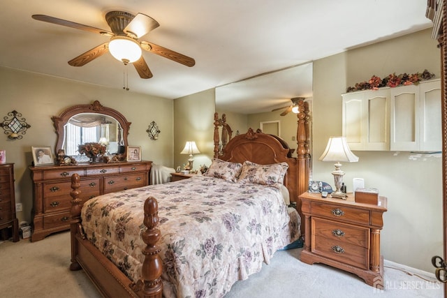 bedroom featuring light carpet and ceiling fan