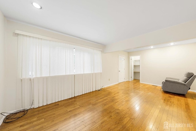 interior space featuring baseboards, hardwood / wood-style floors, and recessed lighting