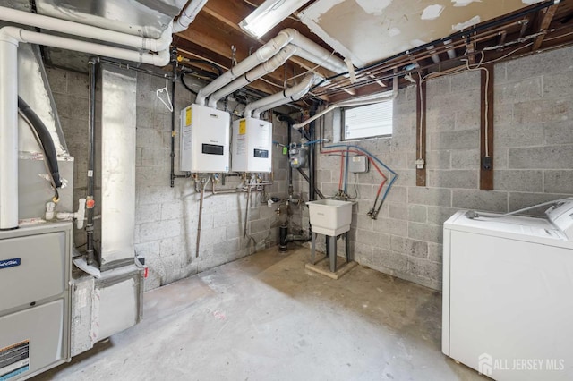 basement with water heater, a sink, washing machine and clothes dryer, and heating unit