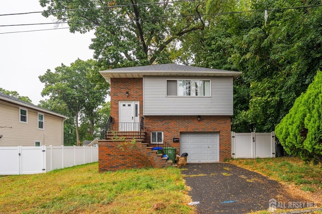 view of front of home with a front yard and a garage