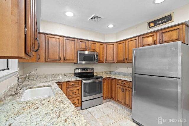 620 Deal Rd Unit 620A, Monroe, NJ 08831 - kitchen with stainless steel appliances, a sink, brown cabinetry, light stone counters, and recessed lighting