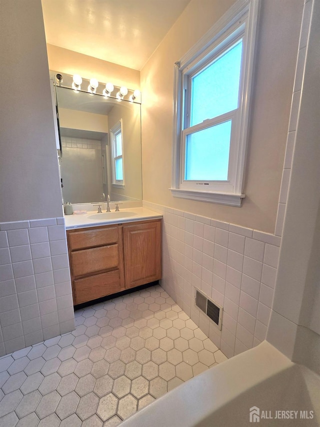20 Ellingham Ave, Monroe, NJ 08831 - bathroom with tile walls, tile patterned floors, vanity, and wainscoting