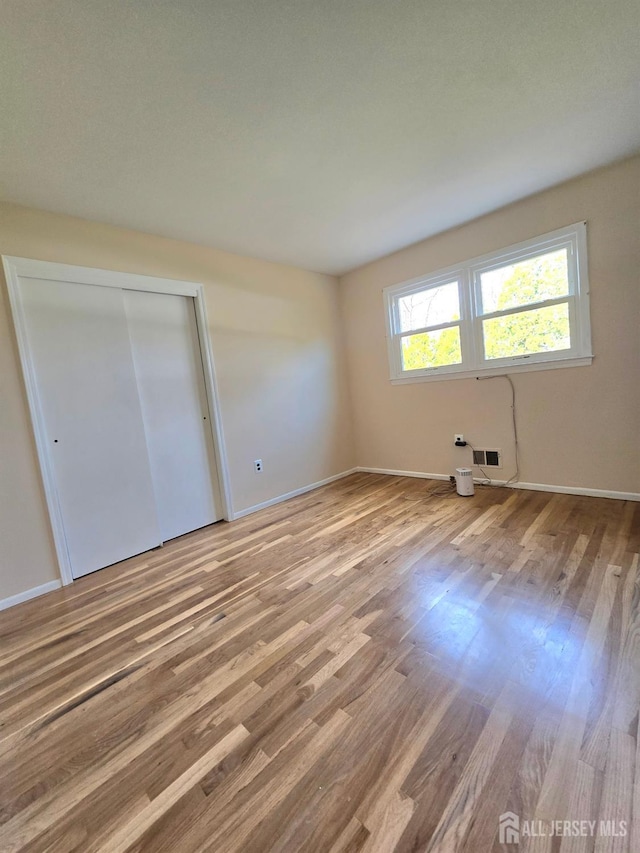 20 Ellingham Ave, Monroe, NJ 08831 - unfurnished bedroom with wood finished floors, baseboards, and a closet