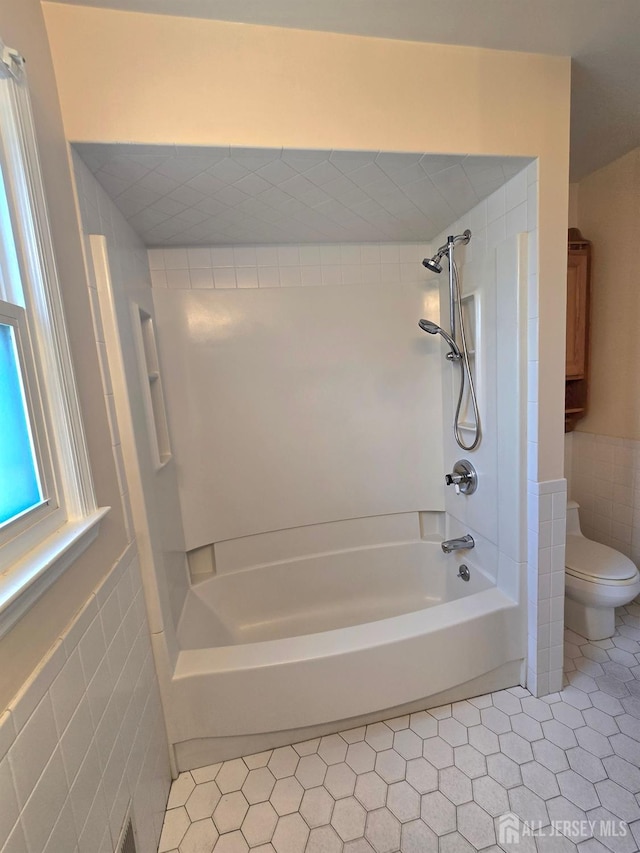 20 Ellingham Ave, Monroe, NJ 08831 - bathroom featuring toilet, tile walls, shower / tub combination, tile patterned flooring, and wainscoting