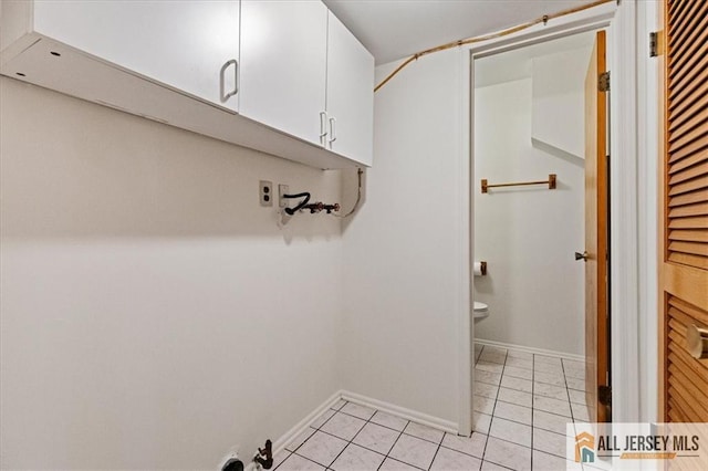 1383 Thomas Ave, North Brunswick, NJ 08902 - laundry area featuring light tile patterned floors, cabinet space, and hookup for a washing machine