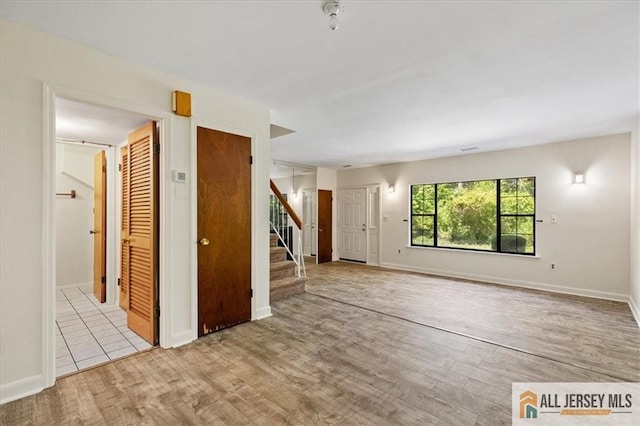 1383 Thomas Ave, North Brunswick, NJ 08902 - unfurnished living room featuring wood finished floors and stairs