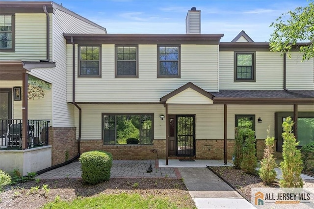 1383 Thomas Ave, North Brunswick, NJ 08902 - townhome / multi-family property with brick siding, a porch, and a chimney