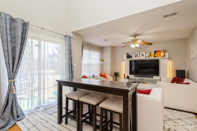 dining space with ceiling fan and visible vents