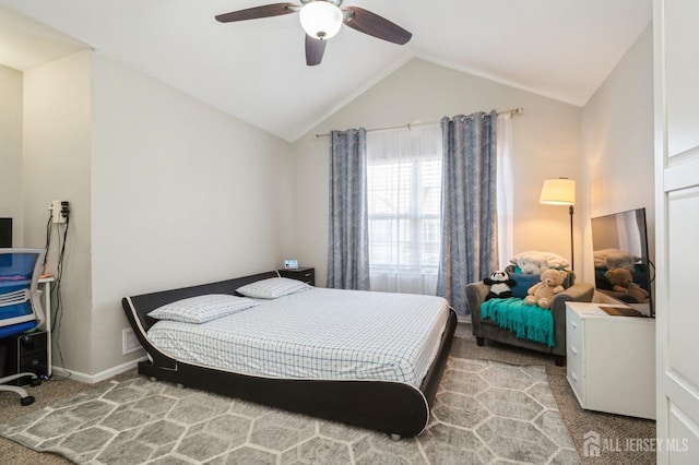 bedroom featuring baseboards, lofted ceiling, carpet, and a ceiling fan