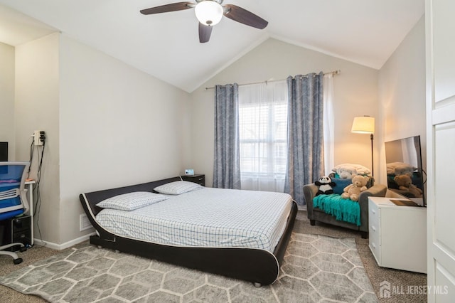 bedroom with baseboards, vaulted ceiling, carpet floors, and a ceiling fan