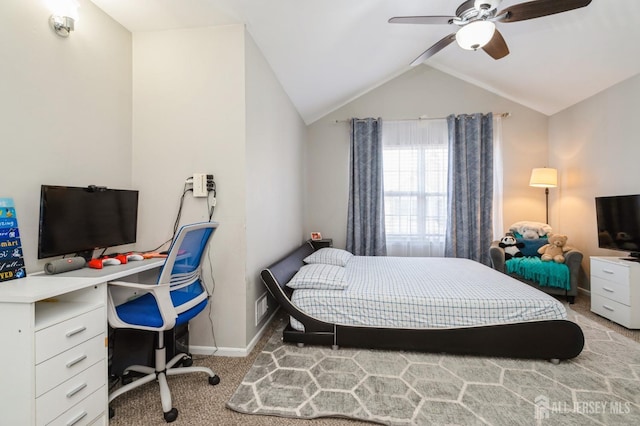 bedroom featuring light carpet, baseboards, vaulted ceiling, and ceiling fan