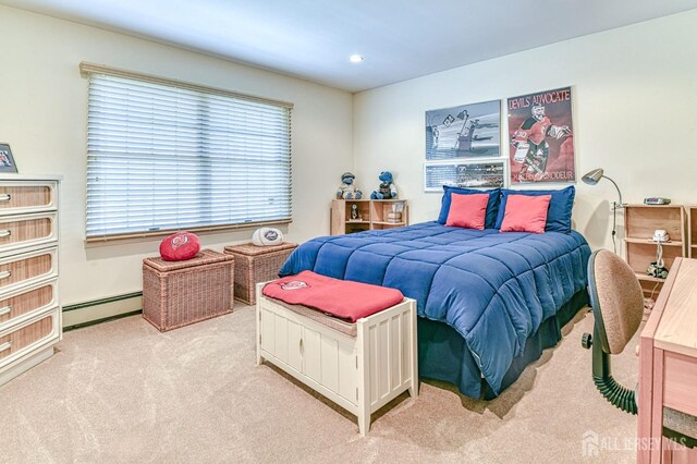 bedroom with a baseboard radiator and light carpet