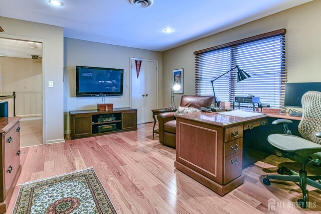 office space with a wealth of natural light and light hardwood / wood-style flooring