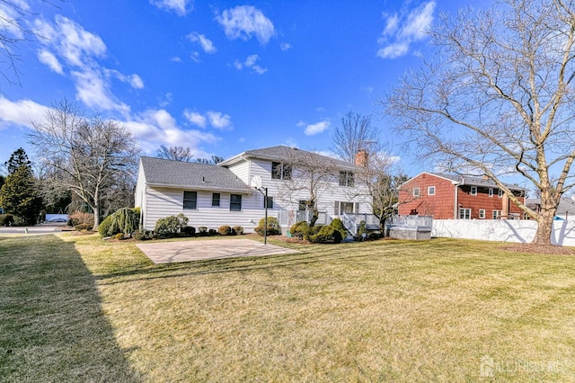 back of property with a patio area and a lawn