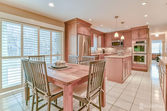 tiled dining room featuring sink