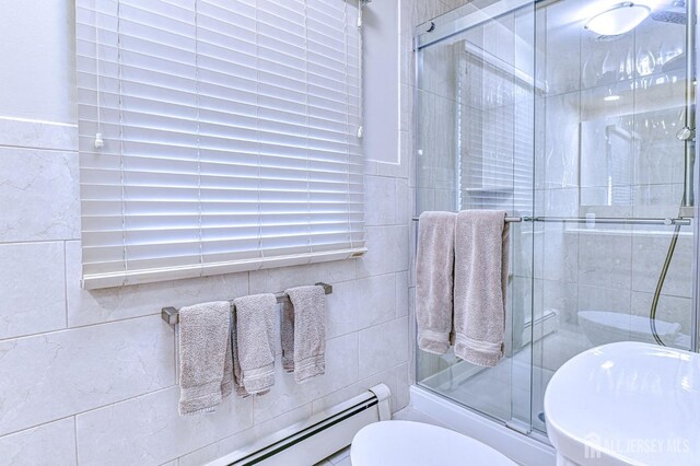 bathroom with tile walls and baseboard heating