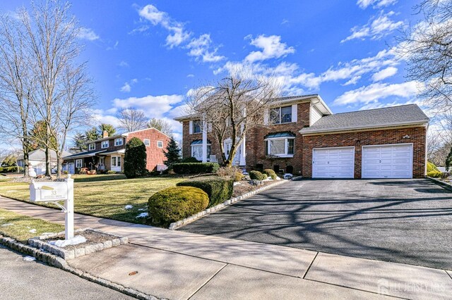 front of property featuring a front yard and a garage