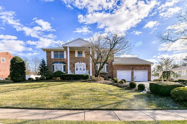 view of front of house featuring a front yard and a garage