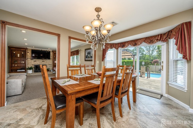 1 Wilfred Rd, Manalapan, NJ 07726 - dining room featuring a chandelier, a brick fireplace, and recessed lighting