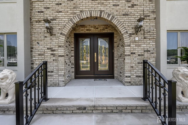 1 Wilfred Rd, Manalapan, NJ 07726 - entrance to property featuring french doors, brick siding, and stucco siding