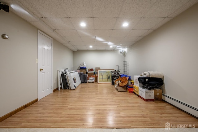 1 Wilfred Rd, Manalapan, NJ 07726 - finished basement featuring light wood-style floors, a baseboard radiator, and recessed lighting