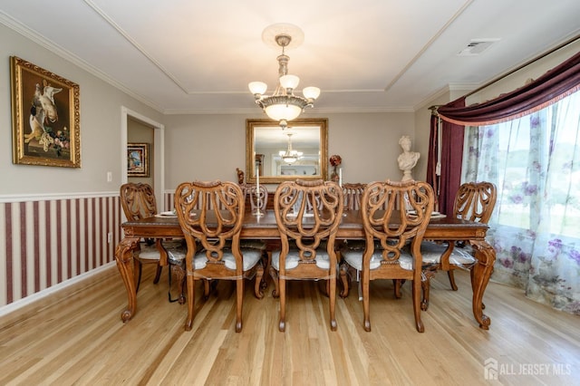 1 Wilfred Rd, Manalapan, NJ 07726 - dining room featuring light wood-style floors, a chandelier, a wainscoted wall, and ornamental molding
