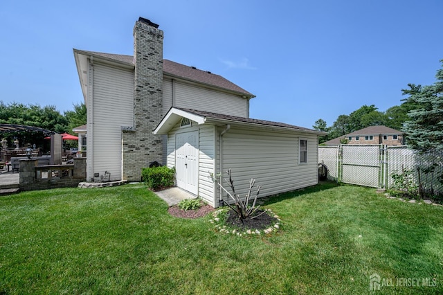 1 Wilfred Rd, Manalapan, NJ 07726 - rear view of property featuring a chimney, an outbuilding, and a patio area