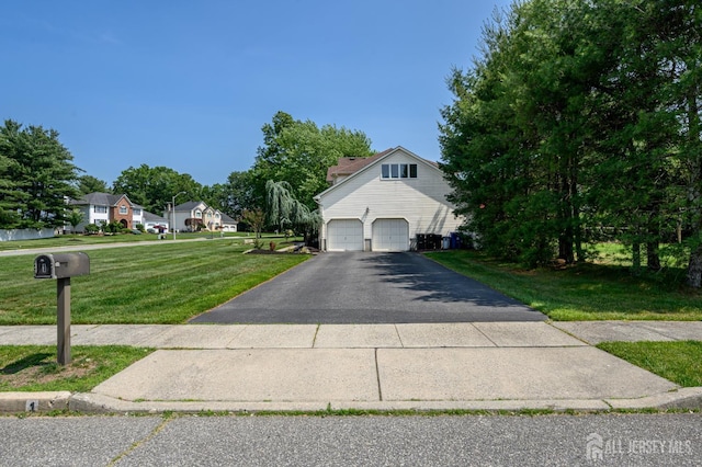 1 Wilfred Rd, Manalapan, NJ 07726 - view of front of home with asphalt driveway and a front lawn