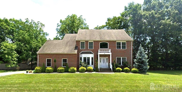7 Rupprecht Rd, North Brunswick, NJ 08902 - view of front facade featuring a front yard, brick siding, and a balcony