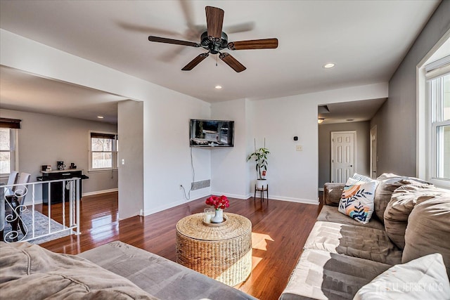 living room featuring recessed lighting, baseboards, and wood finished floors