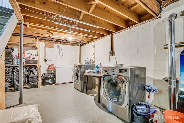 clothes washing area featuring washer and dryer and laundry area