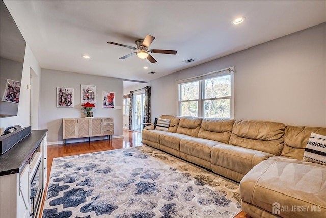 living area with a ceiling fan, wood finished floors, visible vents, baseboards, and recessed lighting