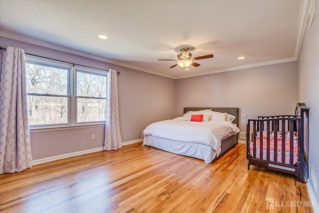 bedroom featuring a ceiling fan, recessed lighting, crown molding, light wood finished floors, and baseboards