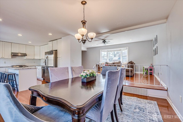 dining space with visible vents, a ceiling fan, wood finished floors, recessed lighting, and baseboards