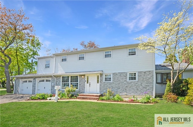 view of front of home featuring a front lawn, driveway, stone siding, and a garage