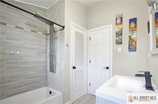 full bath featuring bathtub / shower combination, vanity, and wood finished floors