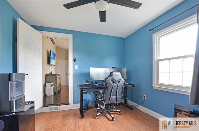 home office with a ceiling fan, wood finished floors, and baseboards