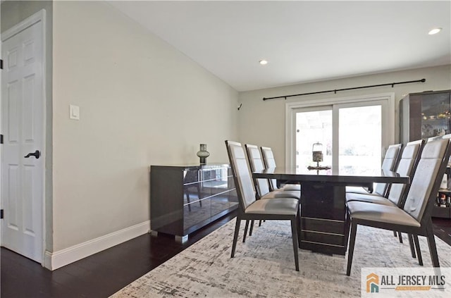 dining area featuring baseboards, wood finished floors, and recessed lighting