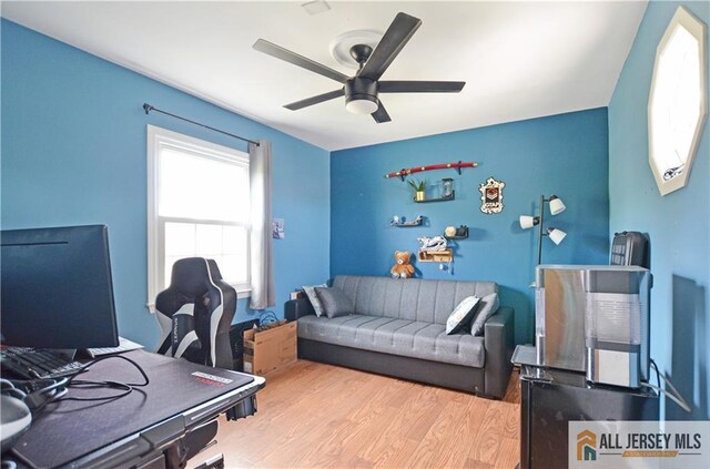 home office with a ceiling fan and wood finished floors