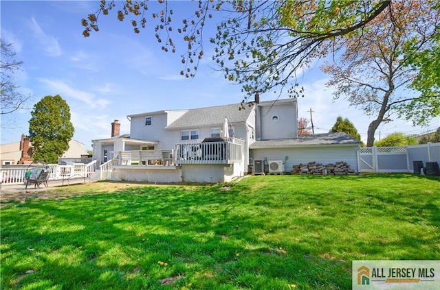 back of property with a wooden deck and ac unit