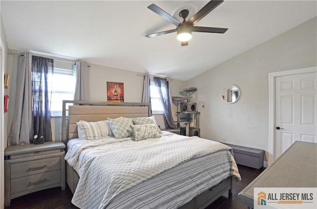 bedroom with vaulted ceiling, dark wood-type flooring, and ceiling fan