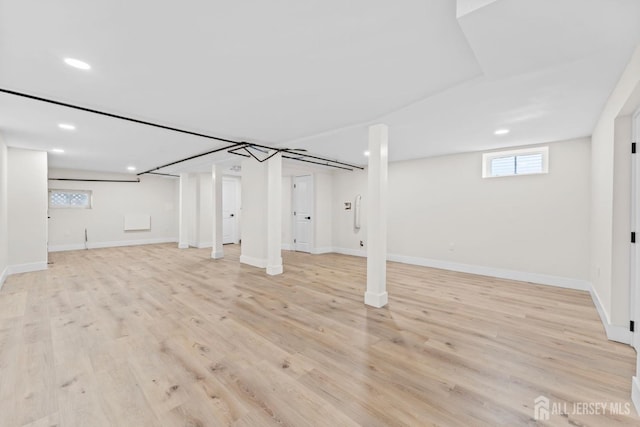 below grade area featuring recessed lighting, baseboards, and light wood-style flooring