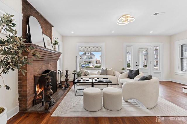 living area featuring wood finished floors, visible vents, and a wealth of natural light